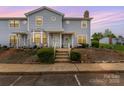 Charming townhome featuring a tidy front yard, steps leading to the entrance, and a welcoming porch at 1424 River Dr, Belmont, NC 28012