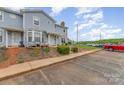 Exterior view of a townhome with front yard, parking area, and proximity to surrounding amenities at 1424 River Dr, Belmont, NC 28012
