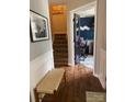 Inviting foyer with hardwood floors, a staircase, and an office space featuring elegant glass doors at 15003 Jerpoint Abby Dr, Charlotte, NC 28273