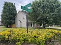 Neighborhood corner street sign with manicured bushes and landscaping at 15003 Jerpoint Abby Dr, Charlotte, NC 28273