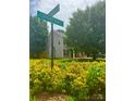 Street view of home showcasing its location with lush greenery and clear street signage at 15003 Jerpoint Abby Dr, Charlotte, NC 28273