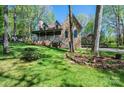 Inviting stone-clad home with a charming porch and beautifully landscaped front yard at 1524 Court Cir, Newton, NC 28658