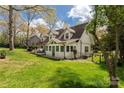 Spacious backyard featuring a patio with outdoor seating, lush green grass, and mature trees at 16 Catawba Ridge Ct, Clover, SC 29710