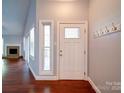 Welcoming foyer features hardwood floors, a decorative front door, and coat hooks at 16149 Haroa Ct, Tega Cay, SC 29708