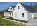 Charming home showcasing white siding, a dark roof, and a front porch with wooden beams at 169 Trinity Ct, Salisbury, NC 28147