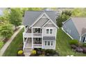 Aerial view of a well-maintained two-story home with double porches and a landscaped yard at 19034 Cypress Garden Dr, Davidson, NC 28036
