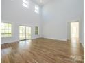 Spacious living room with high ceilings, hardwood floors, large windows, and access to the deck at 2008 Plain Field Dr, Bessemer City, NC 28016