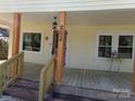 Inviting covered front porch showcasing natural wood columns and ample space for seating and decor at 202 S Love Chapel Rd, Stanfield, NC 28163