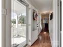 Inviting entryway with hardwood floors, and a bright view of the front porch and neighborhood beyond at 220 Tomberlin Rd, Mount Holly, NC 28120