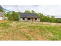 Well-maintained house featuring green siding, a dark roof, and a spacious lawn at 2212 University Dr, Lancaster, SC 29720