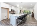 Beautiful kitchen featuring white cabinets, stainless steel appliances, and a large island with bar seating at 24558 Blue Heron Cir # 402, Lancaster, SC 29720