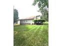 Spacious backyard featuring lush green grass, mature trees, and a tranquil setting at 317 Robert Keever Rd, Stanley, NC 28164