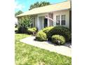 Landscaped front yard with mature shrubs and sidewalk leading to front door, with flag at 317 Robert Keever Rd, Stanley, NC 28164