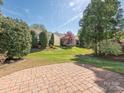 Well-maintained backyard features a brick patio and lush landscaping at 43014 Mimosa Ct, Indian Land, SC 29707