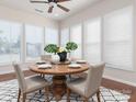Bright dining room features large windows, natural light and a stylish modern table with seating for four at 43014 Mimosa Ct, Indian Land, SC 29707
