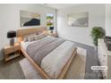 Comfortable main bedroom with neutral decor, carpet, and bright windows at 4437 Devonhill Ln, Charlotte, NC 28269