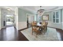 Elegant dining room featuring a chandelier, hardwood floors, and wainscoting details at 5025 Willing Ct, Fort Mill, SC 29707