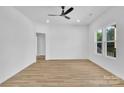 Bright bedroom with modern ceiling fan, wood-look flooring, and large windows for natural light at 504 Christopher Ln, Chester, SC 29706