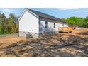 Exterior view of the home's rear featuring classic siding, a wooden deck, and an HVAC unit at 504 Christopher Ln, Chester, SC 29706