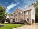 Two-story brick home featuring a lush green lawn and an attached two-car garage at 5621 Landale Ct, Concord, NC 28027