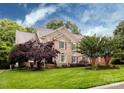 Beautiful two-story brick home with well-manicured lawn and lovely trees at 5621 Landale Ct, Concord, NC 28027