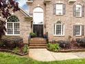 Elegant brick home featuring an attractive front door with decorative wrought iron at 5621 Landale Ct, Concord, NC 28027