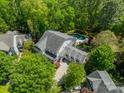 Aerial view of home showcasing the backyard pool and mature trees at 5868 Savona Ter, Fort Mill, SC 29708
