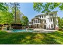 Gorgeous backyard pool with a waterfall feature and covered patio at 5868 Savona Ter, Fort Mill, SC 29708