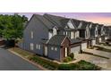 Beautiful townhouse featuring an attached garage, manicured landscaping, and a sidewalk at 5908 Glassport Ln, Charlotte, NC 28210