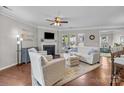 Bright living area with a fireplace, ceiling fan, hardwood floors, and plenty of space for relaxation at 5908 Glassport Ln, Charlotte, NC 28210