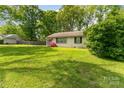 Charming single-story brick home with lush lawn and mature landscaping at 627 Gray Dr, Charlotte, NC 28213