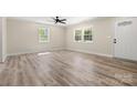 Spacious living room with ample natural light, ceiling fan and wood-look floors at 6525 Kershaw Camden Hwy, Heath Springs, SC 29058