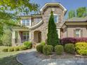 Charming stone front exterior with manicured landscaping and a welcoming porch, showcasing curb appeal at 712 Chase Ct, Fort Mill, SC 29708