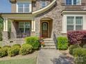 Close-up of the front entrance, featuring a stone facade, decorative door, and landscaped pathway at 712 Chase Ct, Fort Mill, SC 29708