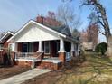 Quaint brick home featuring a welcoming front porch with white columns and a brick staircase at 8350 Nc Hwy 90 E Hwy, Stony Point, NC 28678