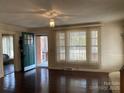Inviting living room with hardwood floors, a front door view and large windows at 8350 Nc Hwy 90 E Hwy, Stony Point, NC 28678