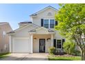 Charming home with front garden, covered porch, and an attached one car garage at 8917 Chalkstone Rd, Charlotte, NC 28216