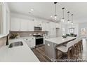 Modern kitchen with stainless steel appliances, white cabinets, and a large central island at 9913 Jack Nicklaus Dr # 908, Lancaster, SC 29720