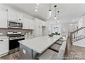 Bright kitchen features a center island, stainless appliances, and ample cabinet space at 9913 Jack Nicklaus Dr # 908, Lancaster, SC 29720