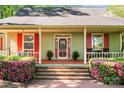 Close-up of the front porch highlighting brick steps and flowering bushes at 101 Blueberry Hill Dr, Statesville, NC 28625