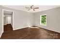 Bright bedroom with hardwood floors, a ceiling fan, and a view of the outdoors at 119 Washington St, York, SC 29745