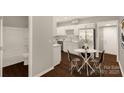 Charming kitchen with a dining table and an adjacent bathroom with a shower and tub at 119 Washington St, York, SC 29745
