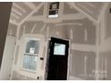 Interior view with new drywall, a black door, and natural light at 122 39Th Avenue Nw Ct, Hickory, NC 28601