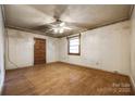 Spacious living room with hardwood floors, a ceiling fan, and a bright window, ready for personal touches at 1430 Bose Ave, Rock Hill, SC 29732