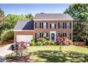 Well maintained two story brick home with a two car garage and landscaped front yard at 145 Meadow Pond Ln, Mooresville, NC 28117