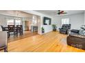 Bright, open living area with hardwood floors, a ceiling fan, and an open layout flowing into the dining area and kitchen at 1540 Neely Store Rd, Rock Hill, SC 29730