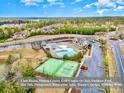 Beautiful aerial view of neighborhood clubhouse and community amenities, including pool, tennis court and playground at 17231 Rider Wood Ln, Charlotte, NC 28278