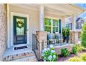 Close-up of a lovely front porch with decorative wreath and cozy seating area at 17231 Rider Wood Ln, Charlotte, NC 28278