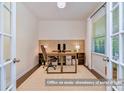Bright home office featuring a modern desk setup and an abundance of natural light at 17231 Rider Wood Ln, Charlotte, NC 28278