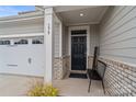 Inviting front entrance showcasing a black door, brick accents, and a cozy bench for added curb appeal at 179 Bezelle Ave # 34, York, SC 29745